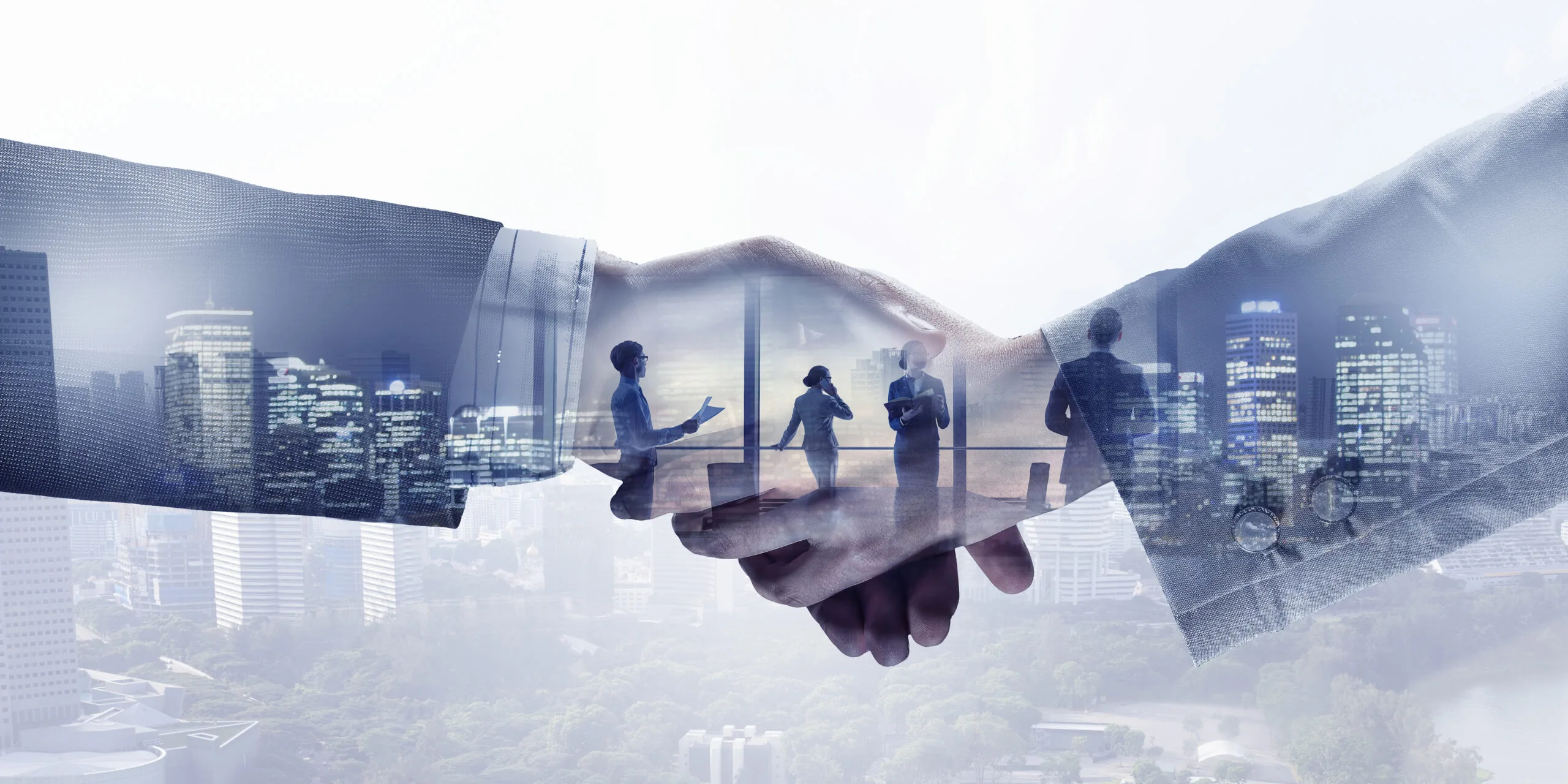 Business handshake with city skyline and professional silhouettes.